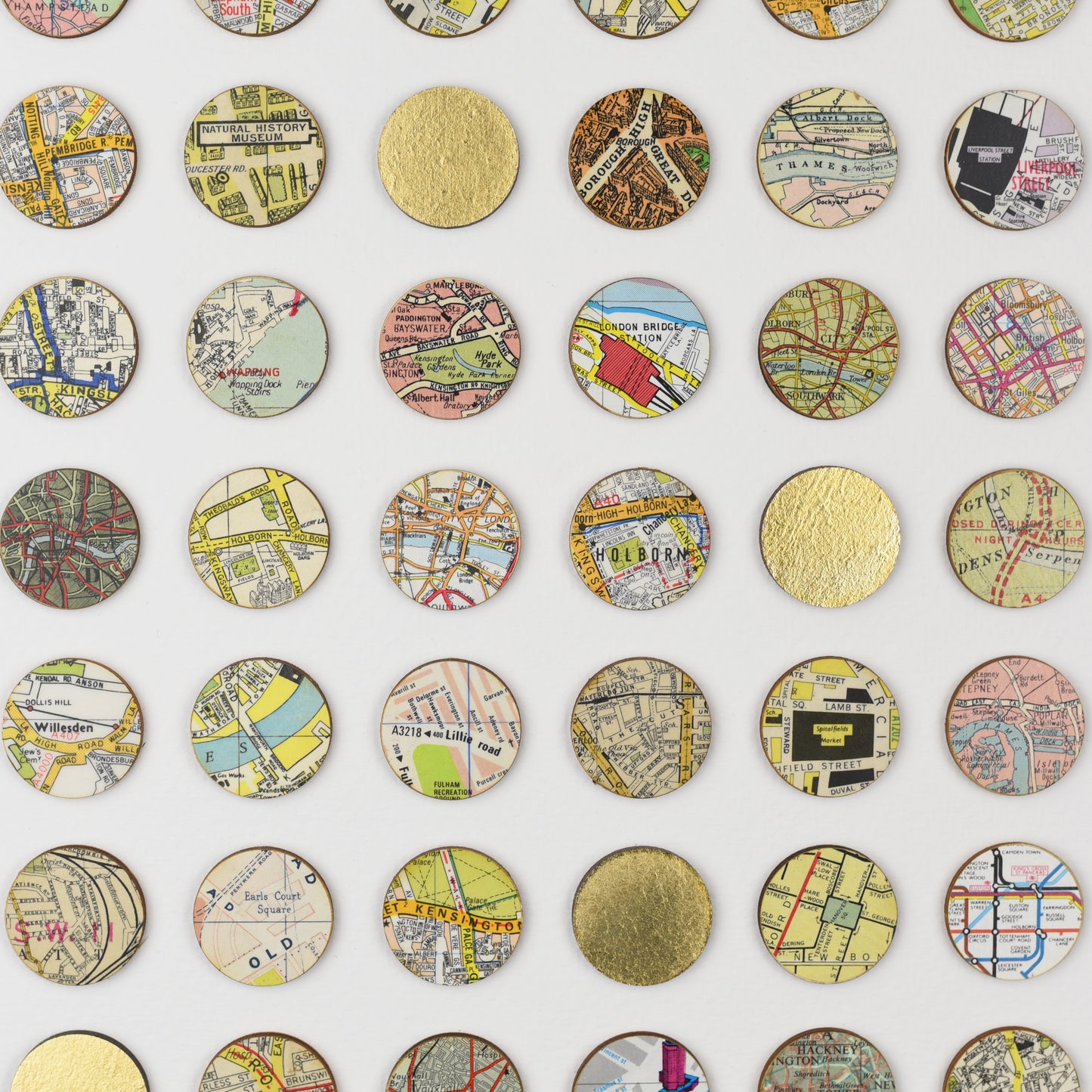 Detail of Amelia Coward's map dots wall art with gold leaf