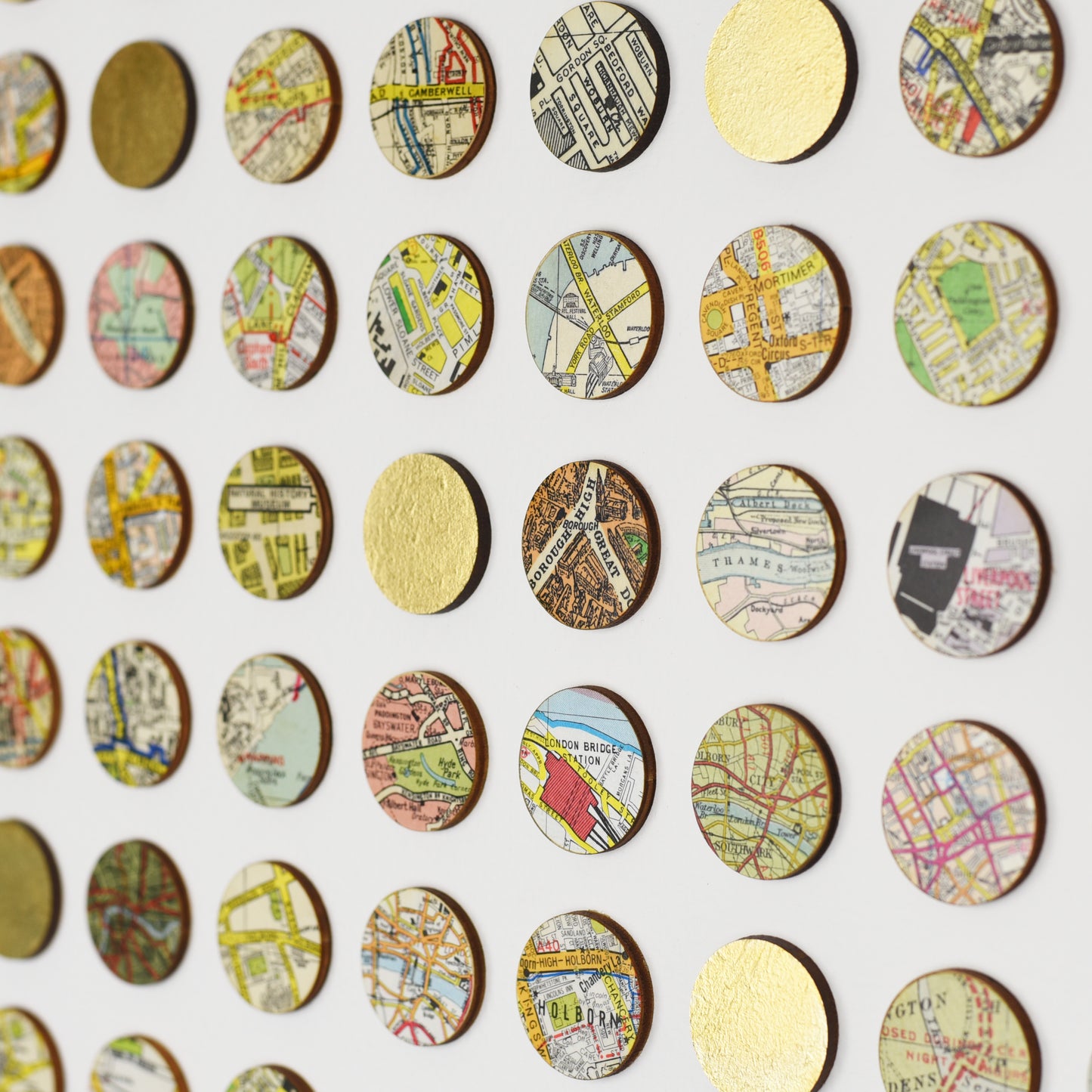 Side detail of Amelia Coward map dot wall art with gold