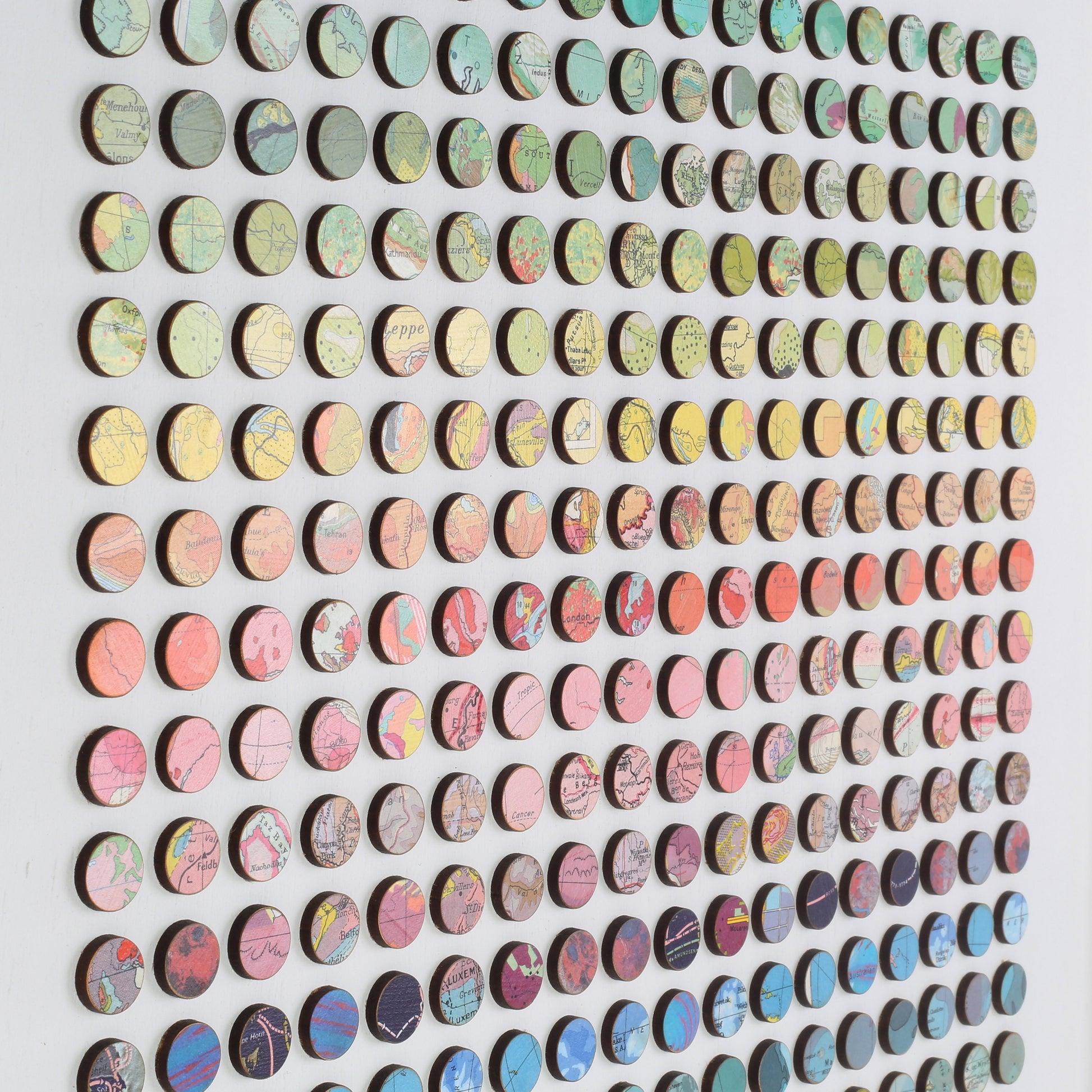 Angle shot of Amelia Coward's 324 map dots rainbow wall art