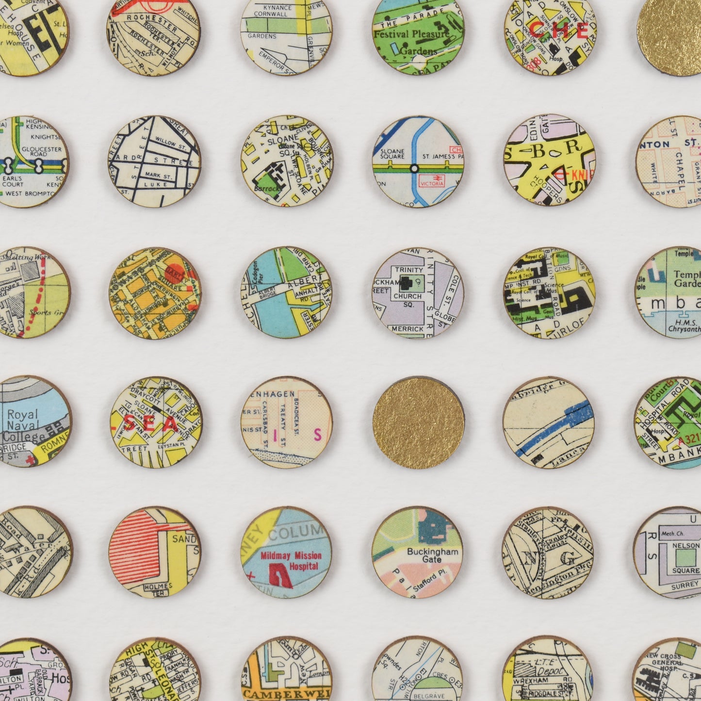 Close up of London may dots wall art by Amelia Coward including gold leaf dots